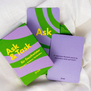 Kartenspiel in grün und lila liegt etwas ausgebreitet auf einem schönen hellbeigen Bettlaken